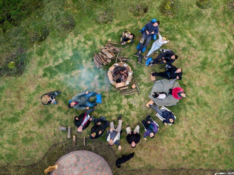 aerial-view-group-people-surrounding-fire-pit-campsite_181624-26063